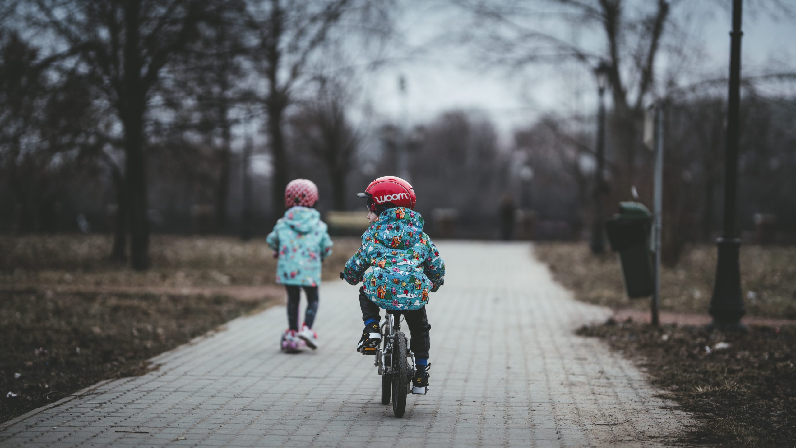 dzieci jadą na rowerch w kaskach